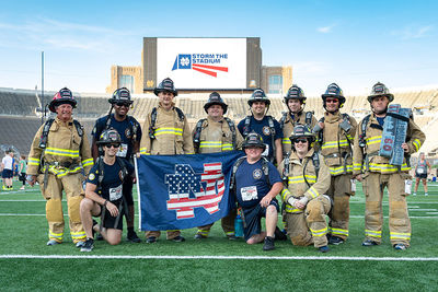 Clay firefighters waive a patriotic Notre Dame flag at "Storm the Stadium"