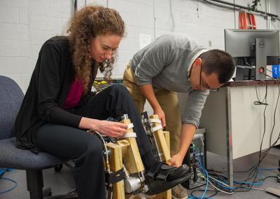 Anne Martin, '14 Ph.D., works to optimize exoskeleton support for walking assistance.