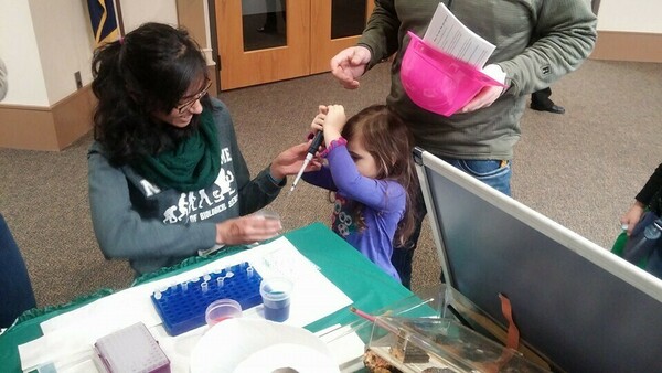 Mauna Dasari instructing young scientists on the proper use of micropipettes at the St. Joseph County Public Library’s “Science Alive!” event in 2016.