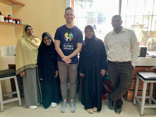 Holzschuh in the lab in Zanzibar with four lab technicians from the Zanzibar Malaria Elimination Programme