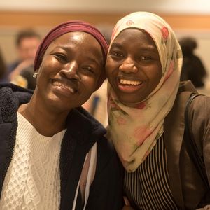 Master of Global Affairs student Mariama S. Dampha (right) celebrates her second-place finish in the 2023 3MT finals with a friend.
