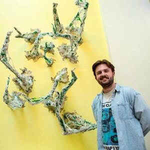 MFA artist Riley Fichter with his installation, 'bahamut'.